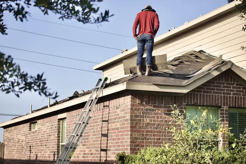 Professional roofer working on a residential roof in Arena District